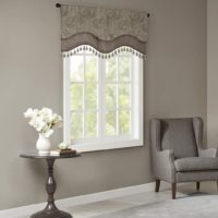 grey scalloped valances with tassels on window