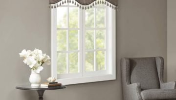 grey scalloped valances with tassels on window