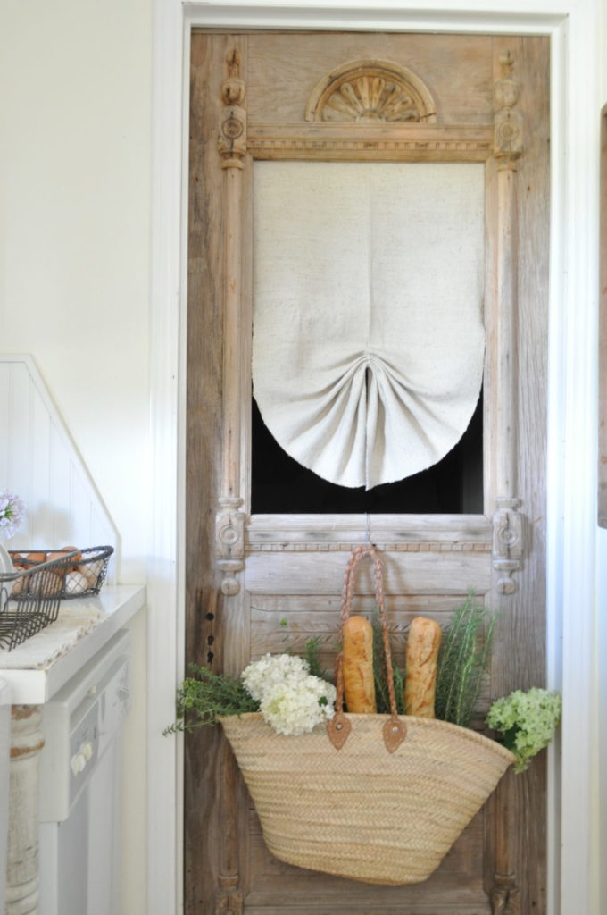 white burlap cloth as curtain on door hung with nail