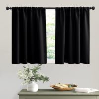 black kitchen curtains hanging on rod behind table