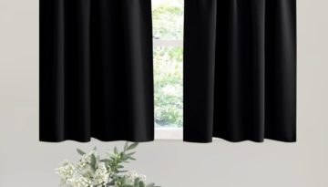 black kitchen curtains hanging on rod behind table